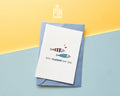 Premium postcard with an original illustration of two small fish (one red striped, one blue dotted) with tiny red hearts and the German text 'ALLES SCHÖNER MIT DIR.', shown with a luxury blue envelope.