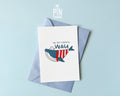 Premium postcard with an original illustration of a blue whale wearing a red striped shirt and a sailor hat with the text 'DU BIST EINFACH WAU', shown with a light blue envelope.