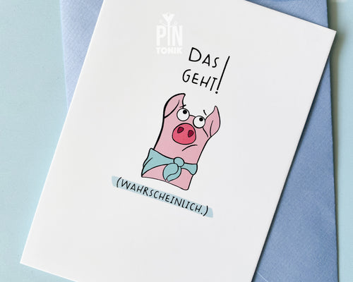 Premium postcard featuring an original illustration of a pink pig wearing a blue scarf with the German text 'Das geht! (Wahrscheinlich.)', shown with a blue envelope on a blue background.