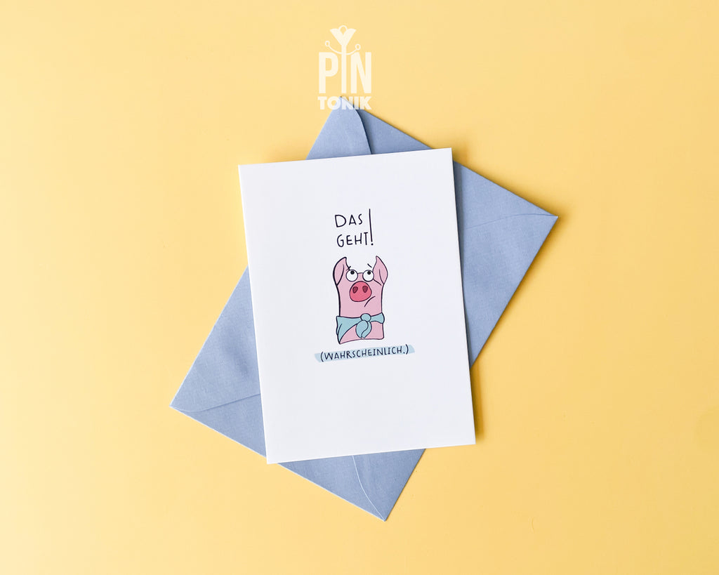 Premium postcard featuring an original illustration of a pink pig wearing a blue scarf with the German text 'Das geht! (Wahrscheinlich.)', shown with a blue envelope on a yellow background.
