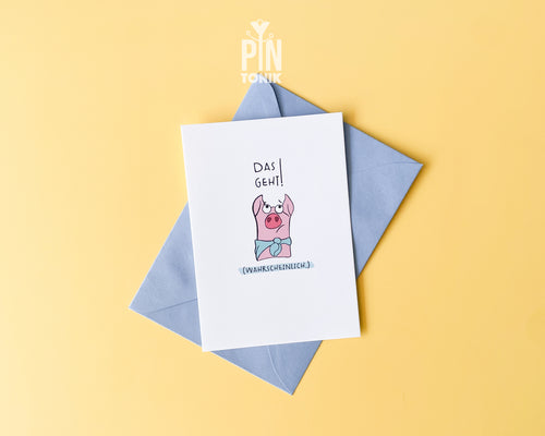 Premium postcard featuring an original illustration of a pink pig wearing a blue scarf with the German text 'Das geht! (Wahrscheinlich.)', shown with a blue envelope on a yellow background.