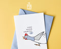 Premium postcard with an original illustration of a chicken and the German text 'SCHON WIEDER GEBURTSTAG. JO.', shown against a yellow background with a light blue envelope