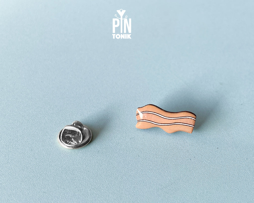 Hand-painted wavy wooden bacon strip pin with tan and white marbled details and a high-gloss finish