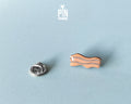Hand-painted wavy wooden bacon strip pin with tan and white marbled details and a high-gloss finish