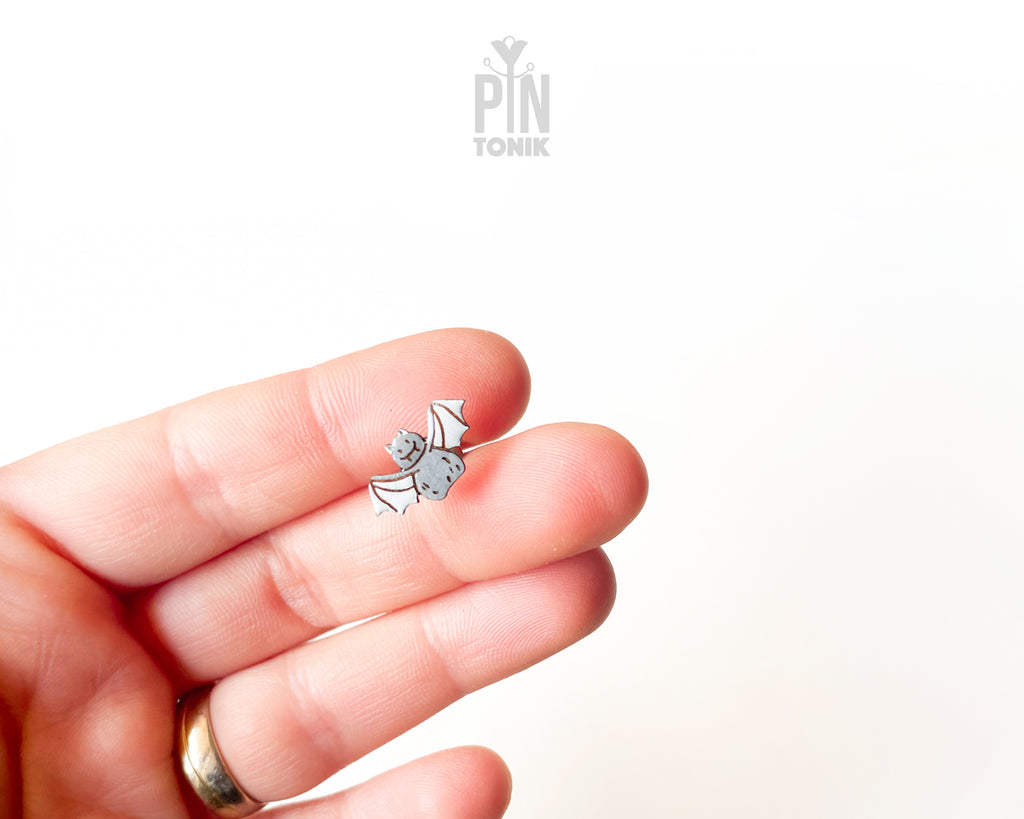 Handmade wooden grey bat stud earrings with outstretched wings by PinTonik, playful spooky and animal themed jewelry.