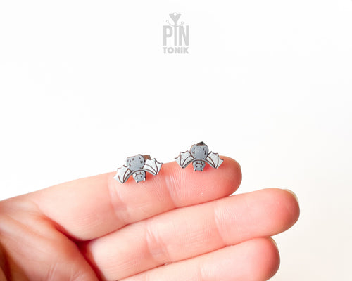 Handmade wooden grey bat stud earrings with outstretched wings by PinTonik, playful spooky and animal themed jewelry.
