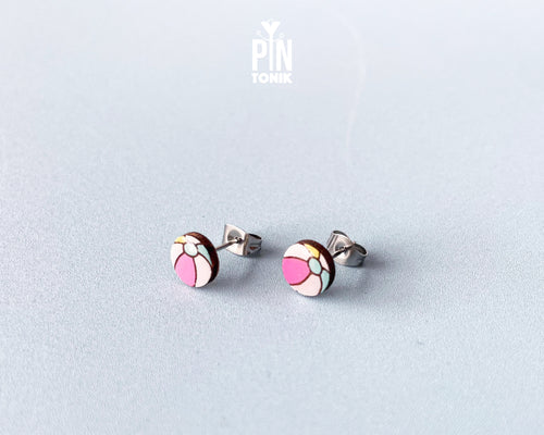 Handmade wooden beach ball stud earrings featuring a cheerful striped pattern of pink, white, and gray panels by PinTonik.