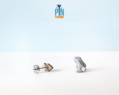 Mismatched hand-painted wooden stud earrings featuring a grey bunny and a bright orange carrot