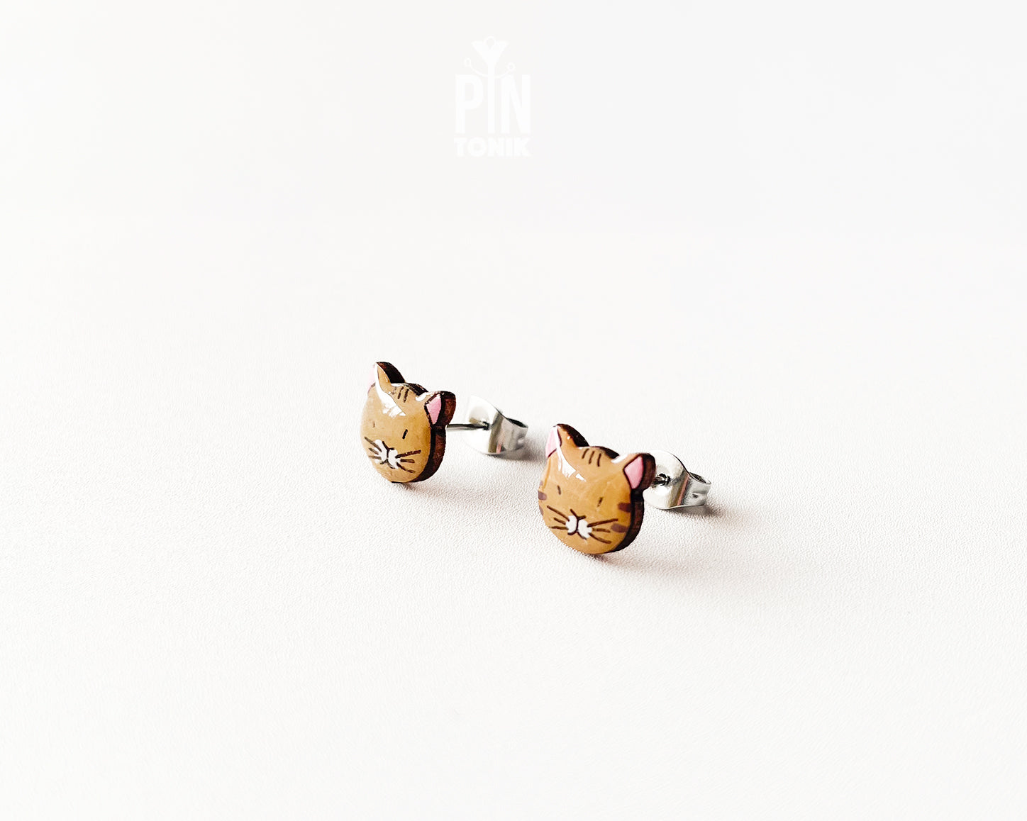 Pair of hand-painted ginger wooden cat stud earrings with a high-gloss protective resin finish