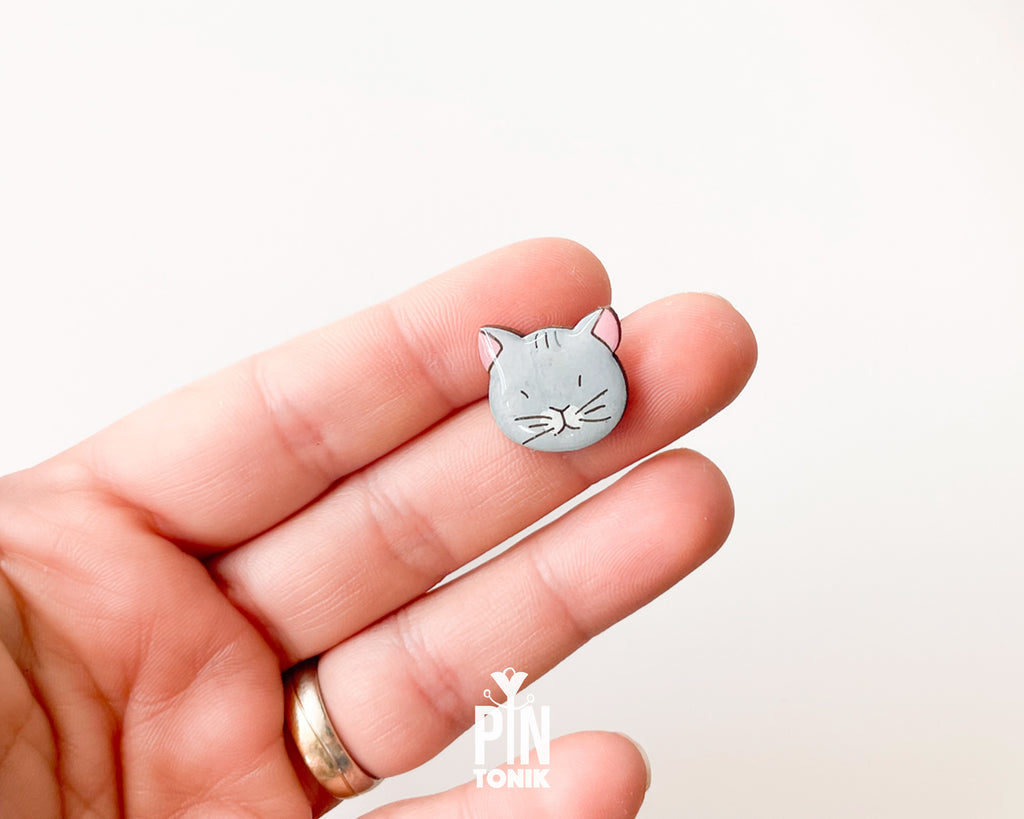 Hand-painted grey wooden cat pin with a high-gloss protective resin finish and a judgmental expression