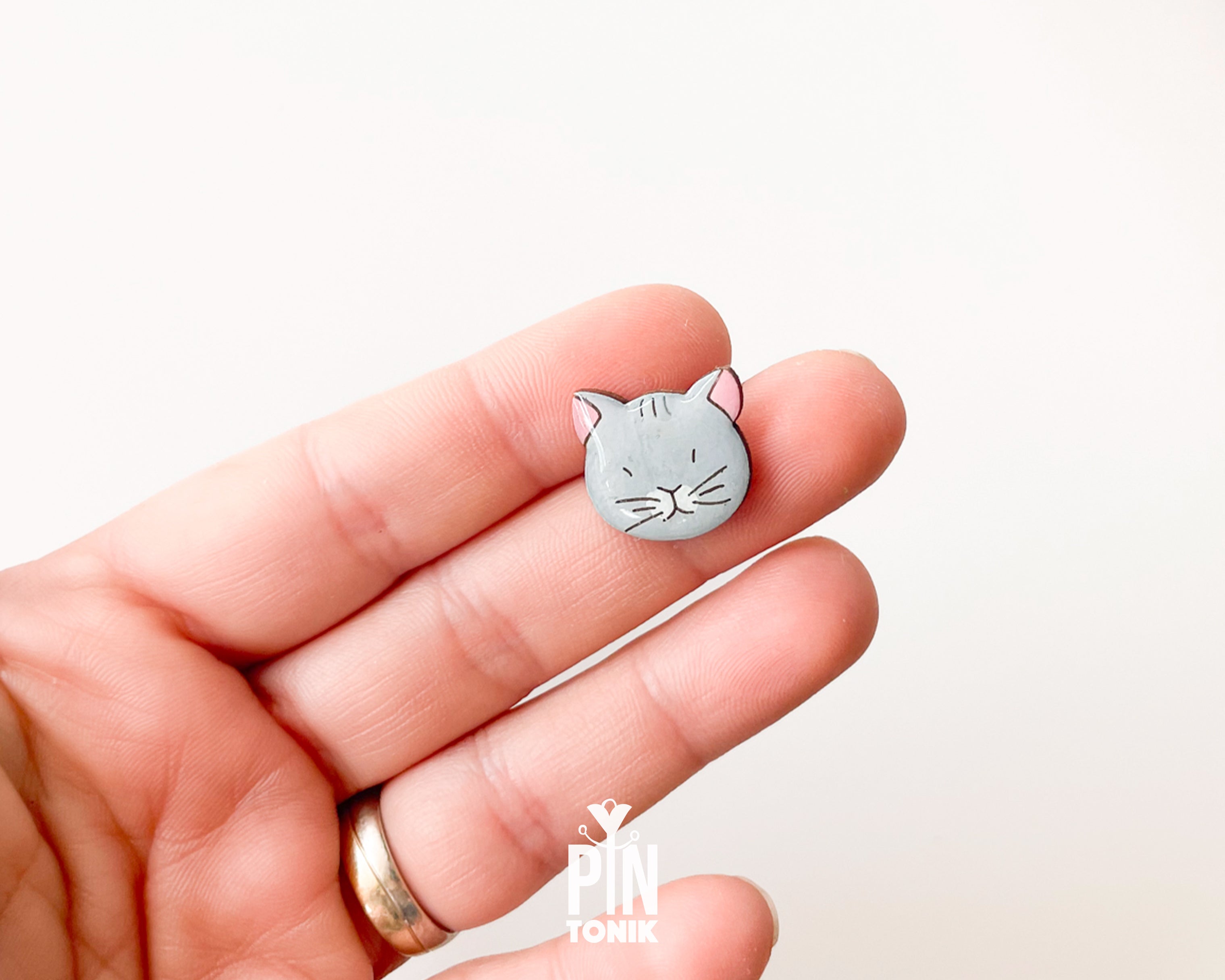 Hand-painted grey wooden cat pin with a high-gloss protective resin finish and a judgmental expression