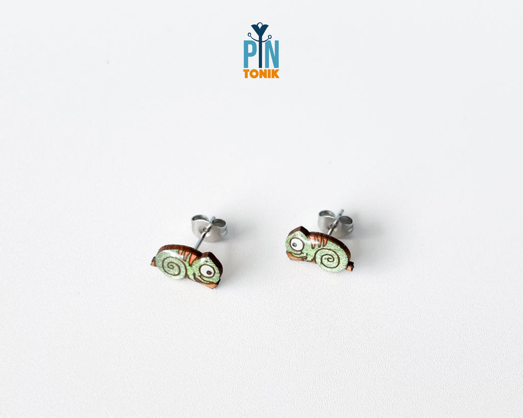 Pair of hand-painted green wooden chameleon stud earrings with a curly tail and glossy resin finish