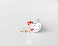 Hand-painted white wooden chicken pin with a red comb and a happy, eyes-closed expression, finished with glossy resin