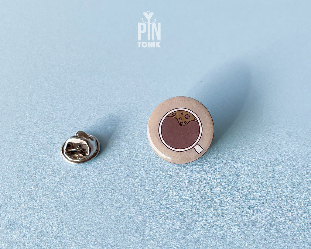 Hand-painted wooden coffee cup pin with latte art and a glossy resin finish