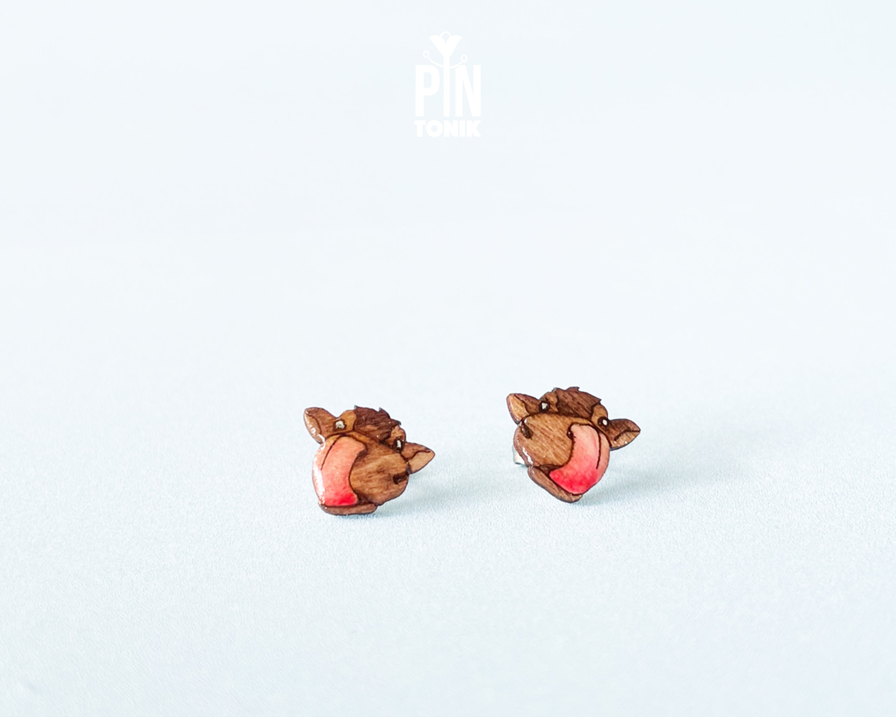 Handmade wooden alpine cow head stud earrings with detailed spots by PinTonik, rustic farmhouse animal themed jewelry.