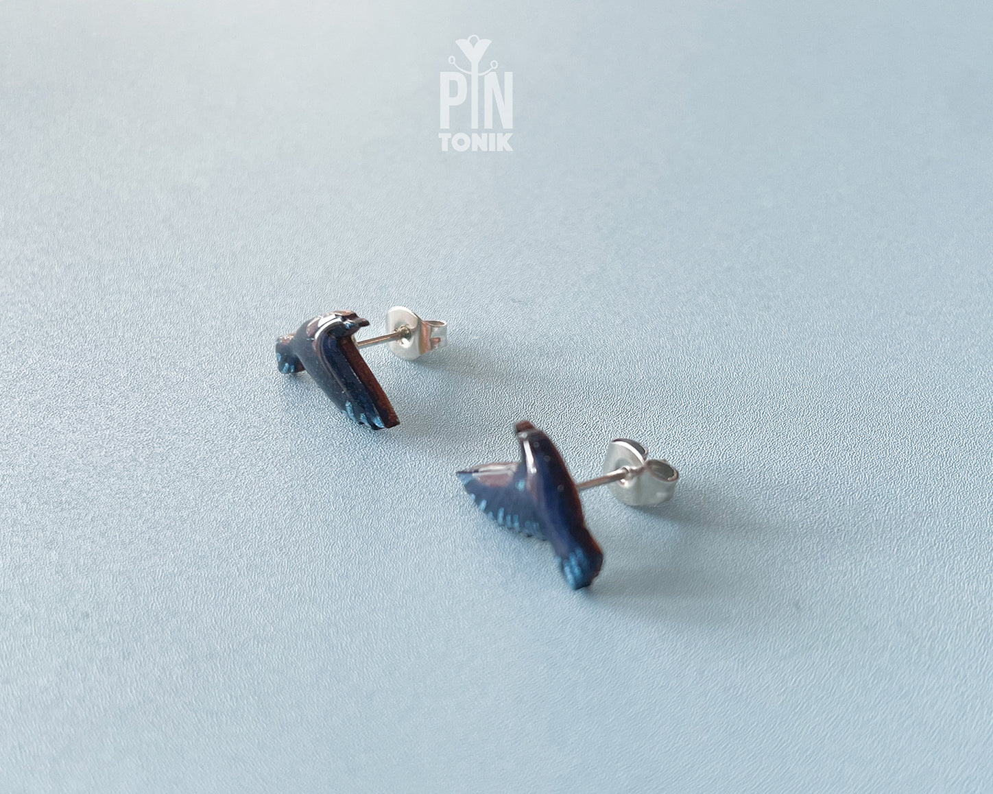 Handmade wooden raven stud earrings in flight with dark blue-black wings by PinTonik, gothic nature and wild bird themed jewelry.