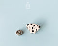 Hand-painted wooden dalmatian dog pin with black spots and a high-gloss resin finish