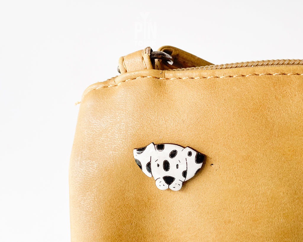 Hand-painted wooden dalmatian dog pin with black spots and a high-gloss resin finish