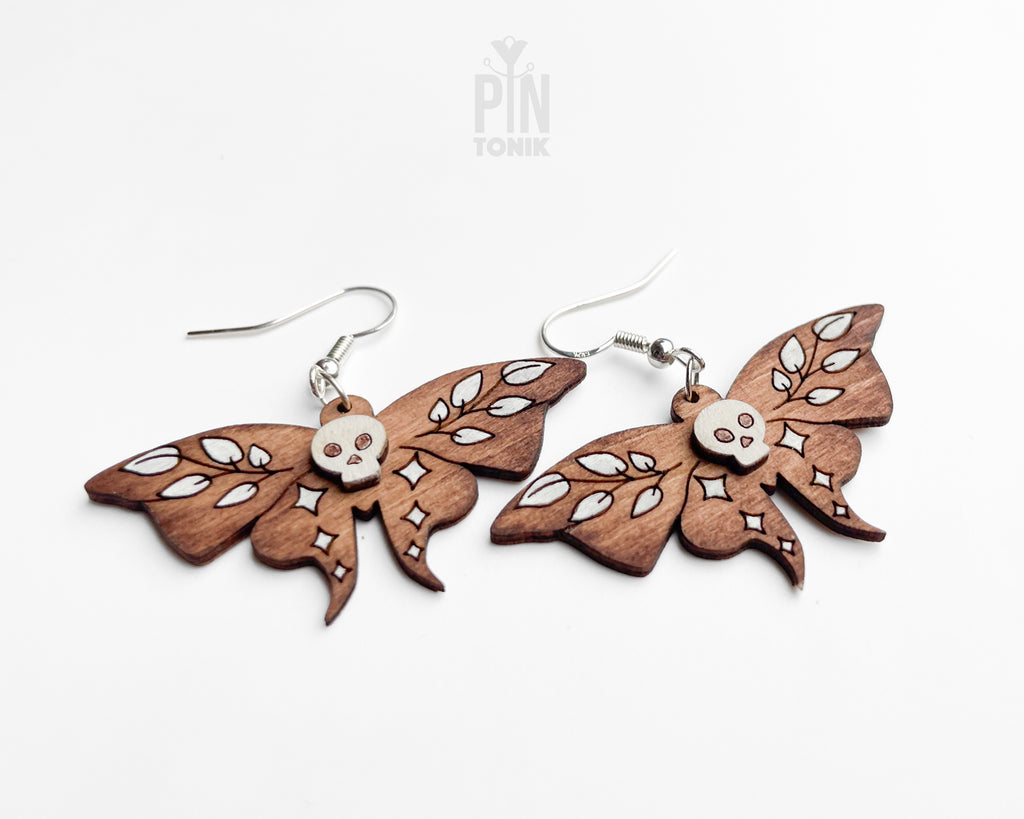 Hand-painted wooden Death's-head Hawkmoth dangle earrings with white skull and wing details on sterling silver hooks