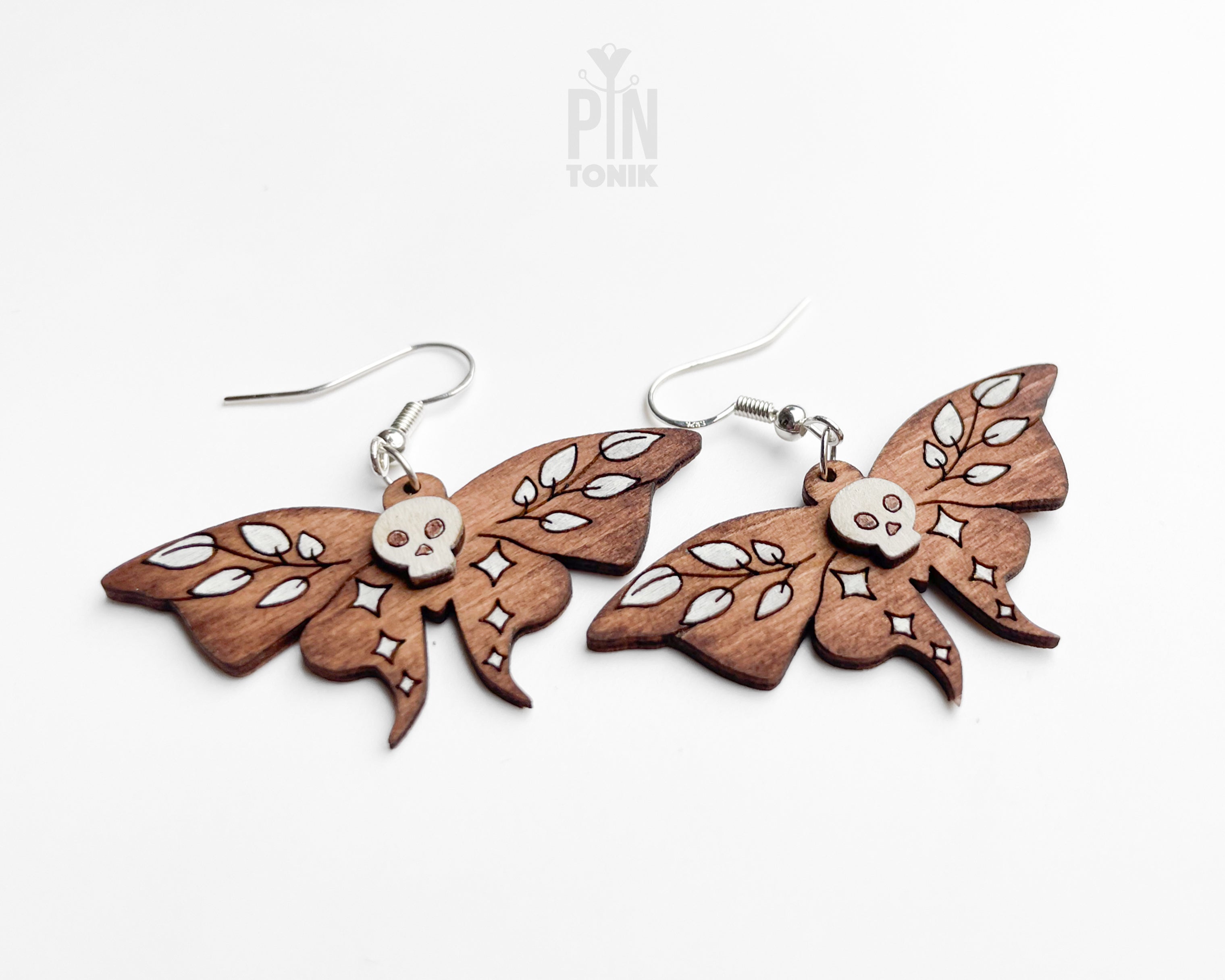 Hand-painted wooden Death's-head Hawkmoth dangle earrings with white skull and wing details on sterling silver hooks