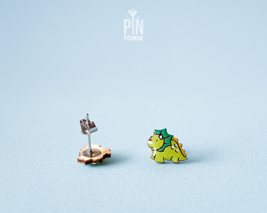 Pair of hand-painted green wooden triceratops dinosaur stud earrings with a high-gloss resin finish