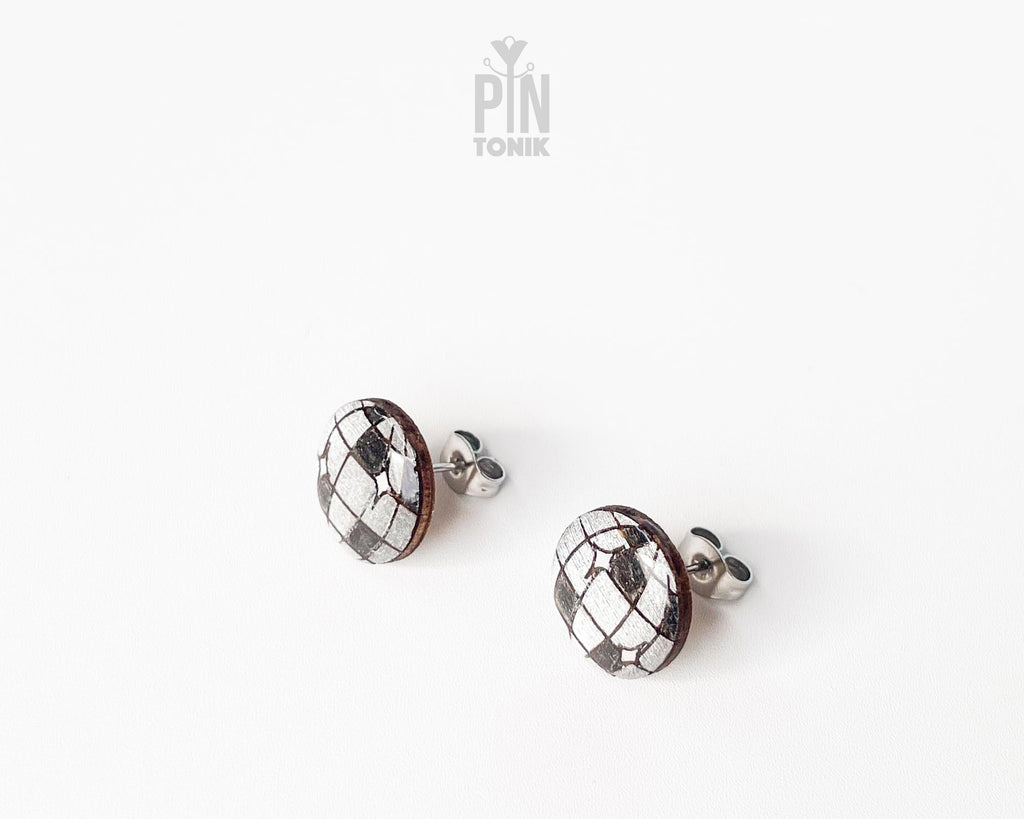 Handmade wooden disco ball stud earrings with a detailed silver and black mirrored facet pattern by PinTonik.