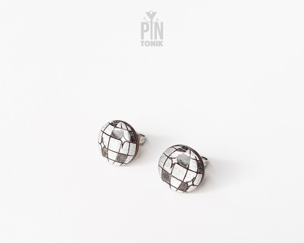 Handmade wooden disco ball stud earrings with a detailed silver and black mirrored facet pattern by PinTonik.
