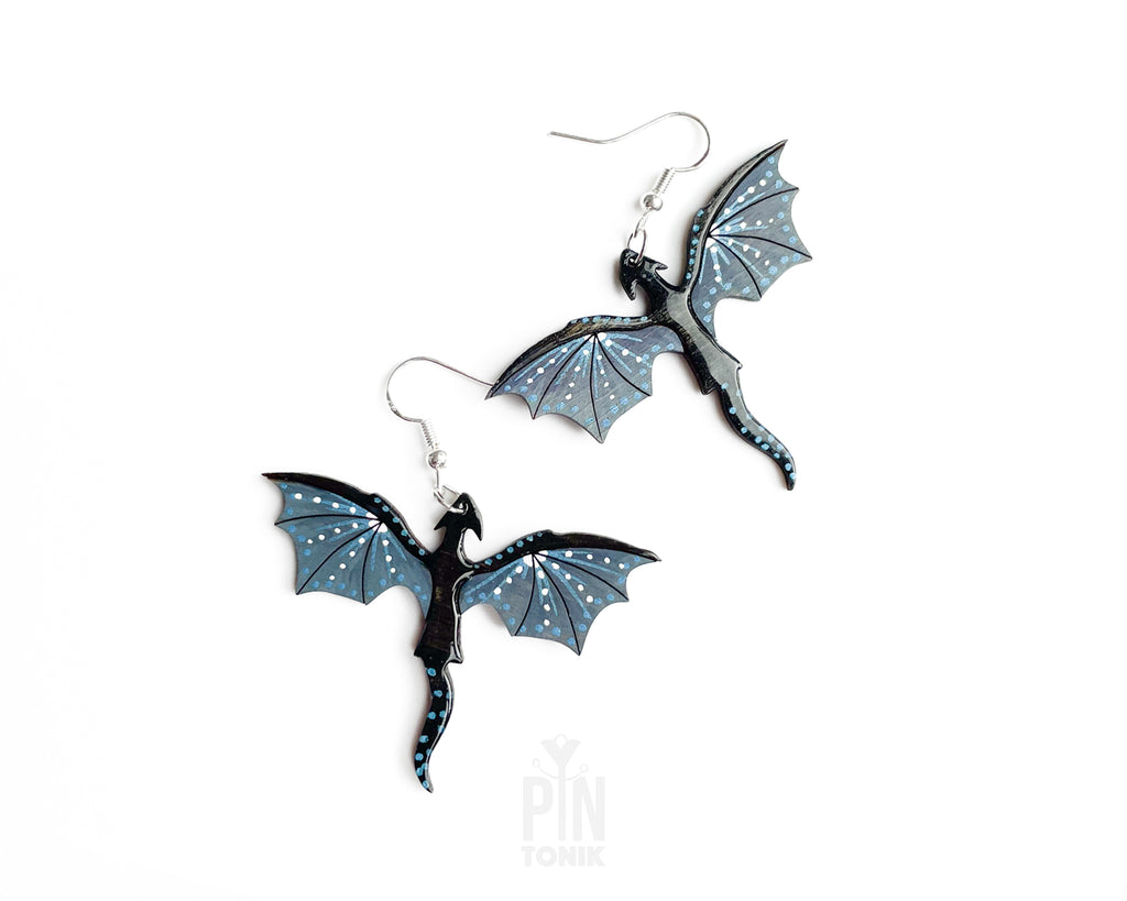 Hand-painted wooden Night dragon dangle earrings with sleek black bodies and speckled blue wing details on sterling silver hooks