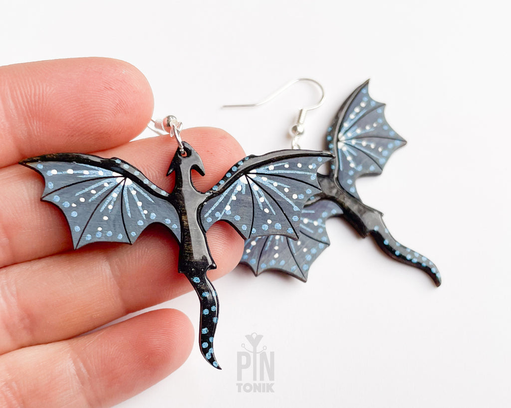 Hand-painted wooden Night dragon dangle earrings with sleek black bodies and speckled blue wing details on sterling silver hooks