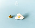 Hand-painted wooden fried egg pin with a bright yellow yolk and white egg white