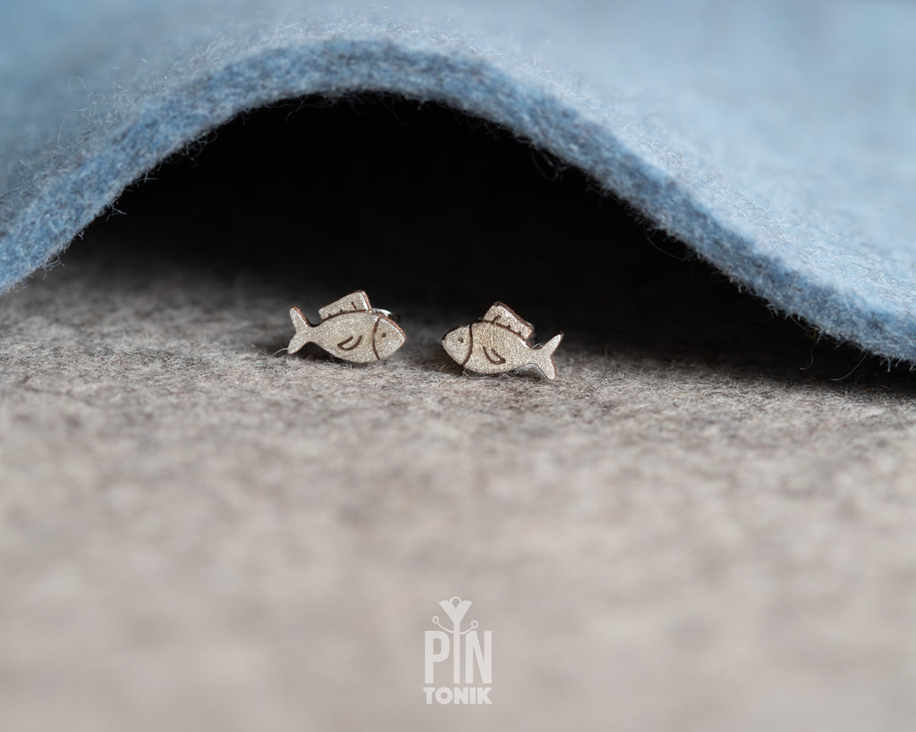 Handmade wooden hatching chick stud earrings with a tiny white eggshell on their head by PinTonik, cute spring and Easter themed jewelry.