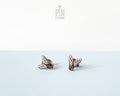 Handmade wooden house fly stud earrings with detailed wings and a black body by PinTonik.