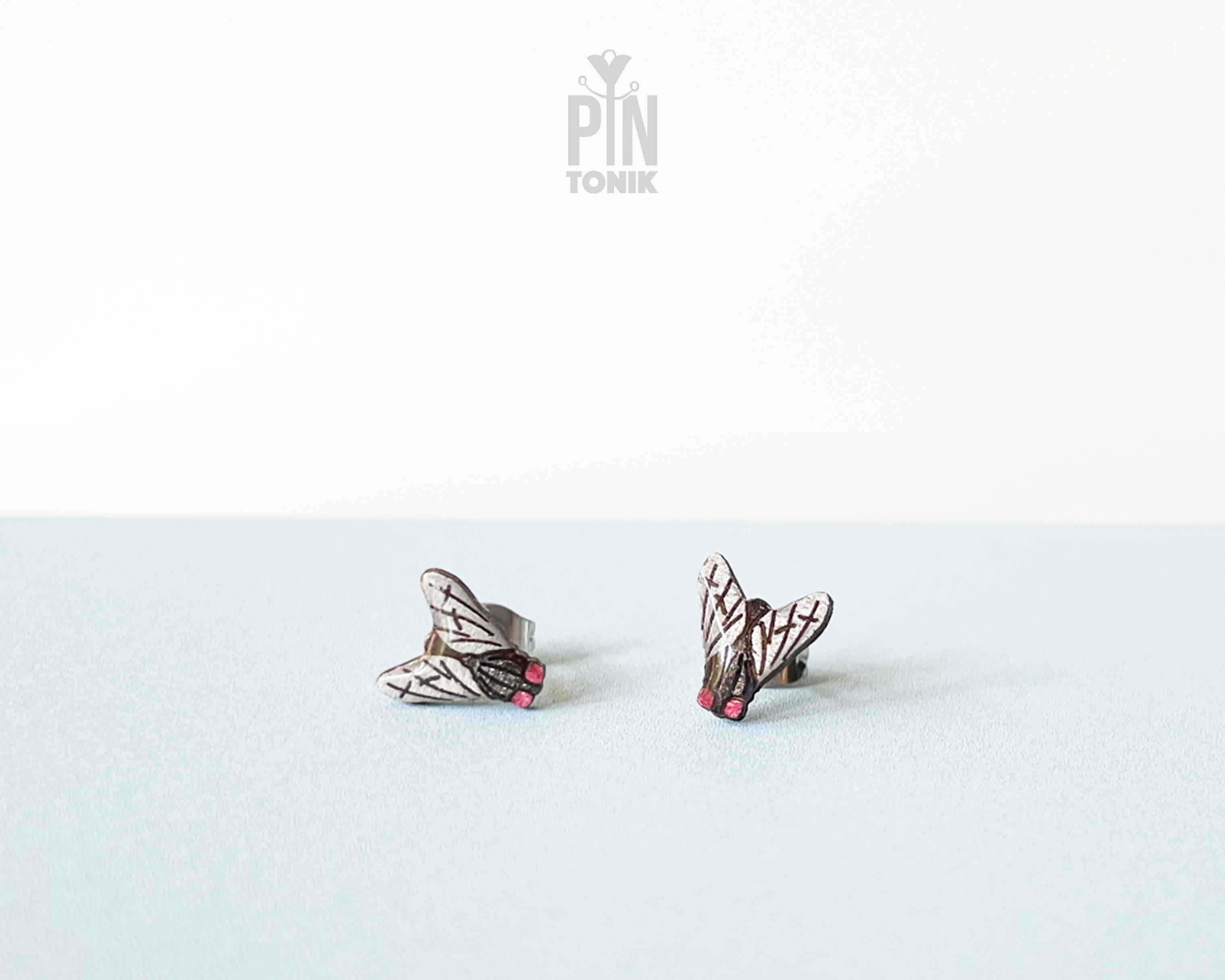 Handmade wooden house fly stud earrings with detailed wings and a black body by PinTonik.