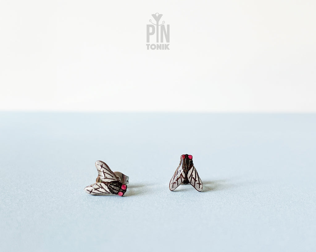 Handmade wooden house fly stud earrings with detailed wings and a black body by PinTonik.