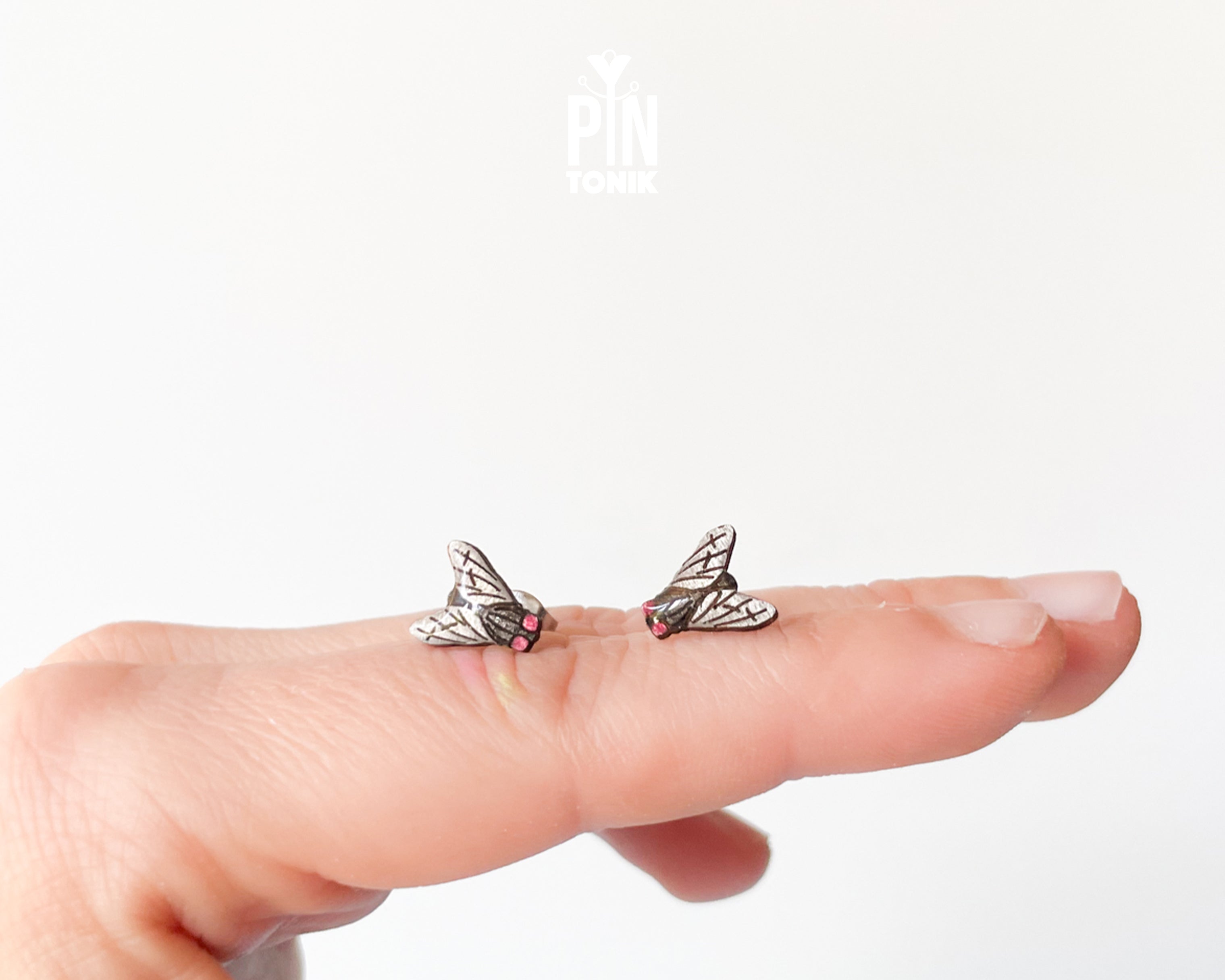 Handmade wooden house fly stud earrings with detailed wings and a black body by PinTonik.