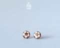 "Handmade wooden soccer ball stud earrings featuring a classic black and white paneled football design by PinTonik."