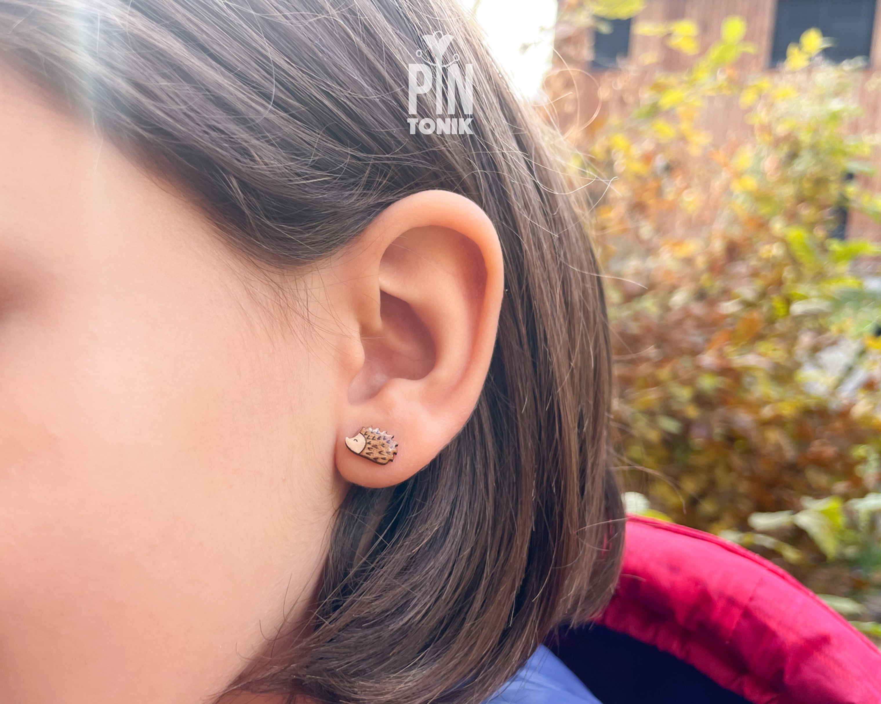 Pair of hand-painted wooden hedgehog stud earrings with detailed brown spikes and a high-gloss resin finish