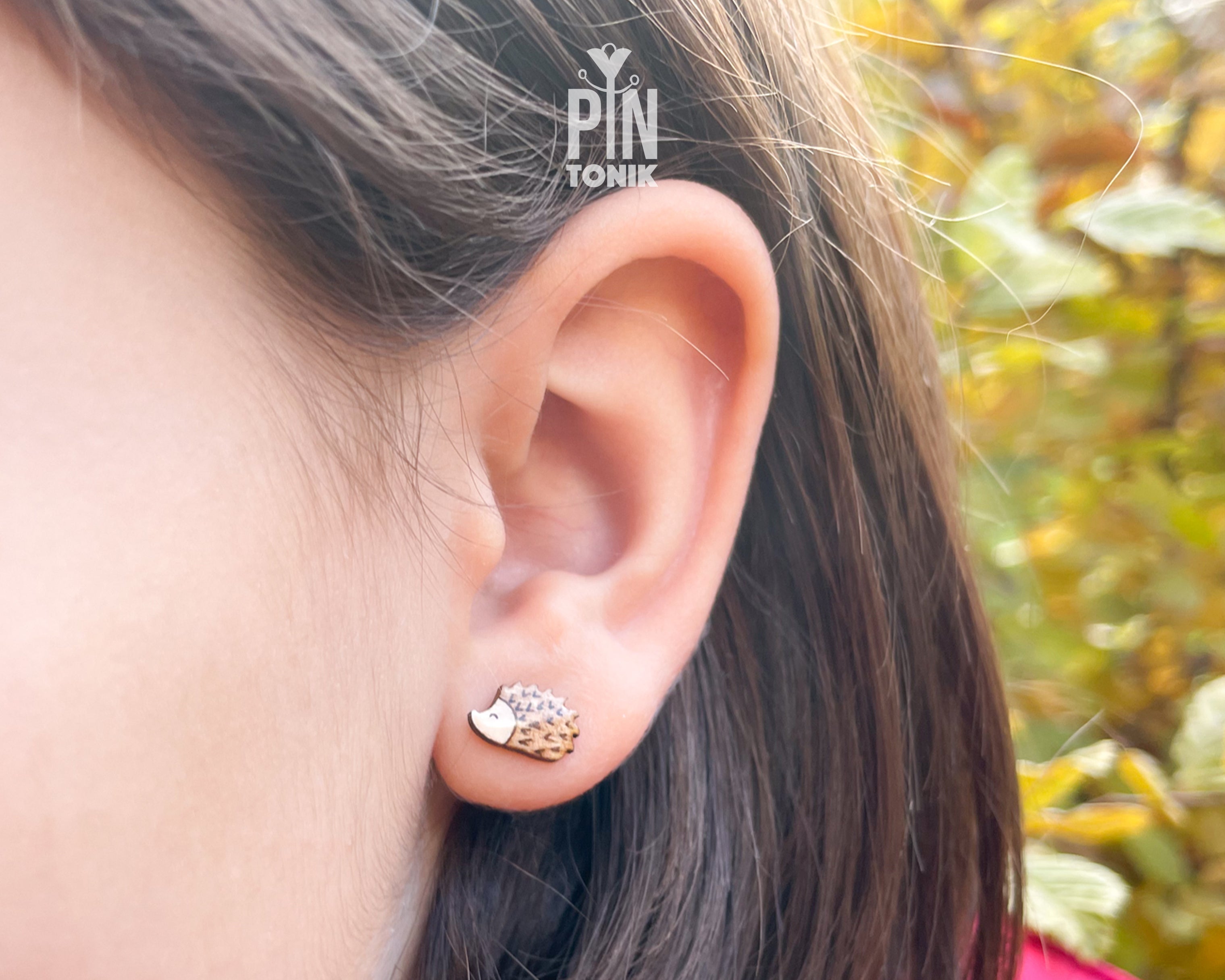 Pair of hand-painted wooden hedgehog stud earrings with detailed brown spikes and a high-gloss resin finish