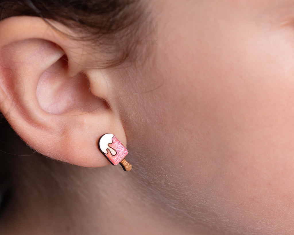 Handmade wooden pink popsicle stud earrings with a melting white cream topping and a tiny wooden stick by PinTonik.