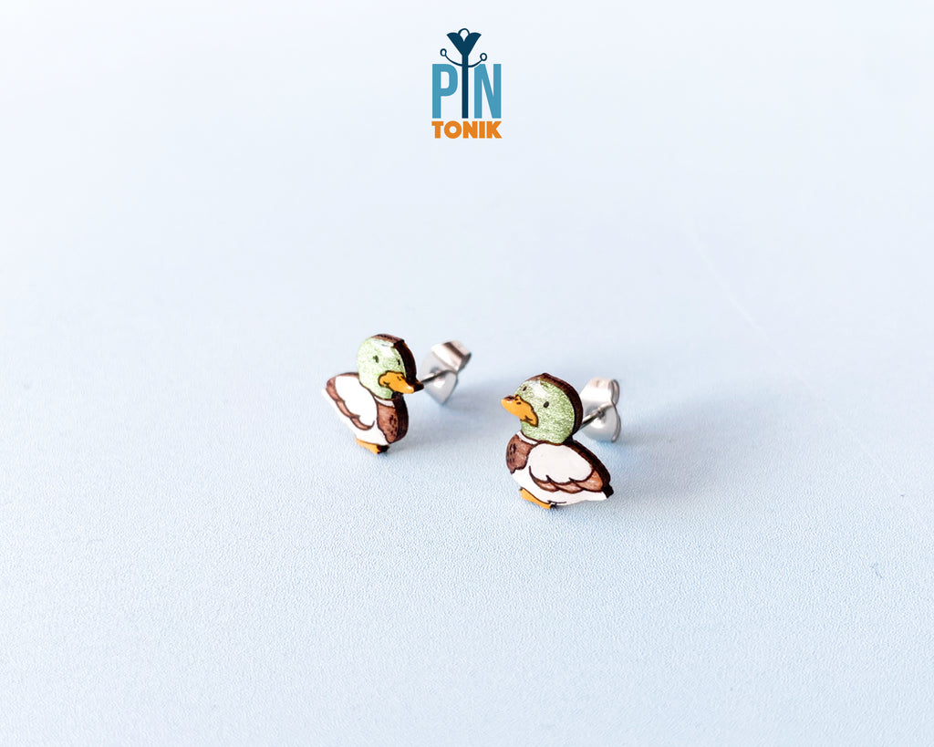 Pair of hand-painted wooden mallard duck stud earrings featuring a green head and brown body with a glossy resin finish
