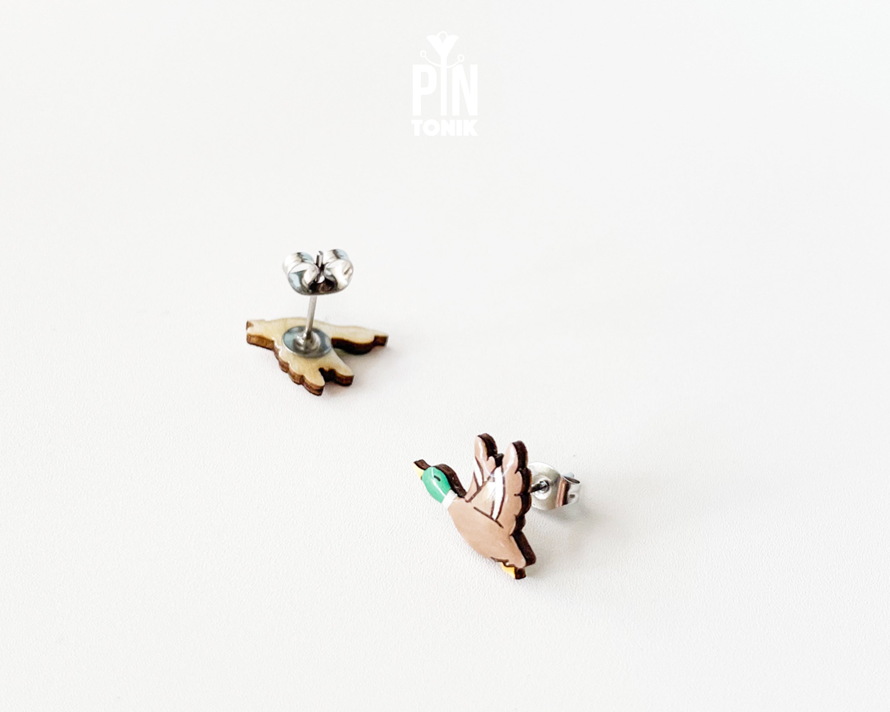 Pair of hand-painted wooden flying mallard duck stud earrings with wings spread and a glossy resin finish