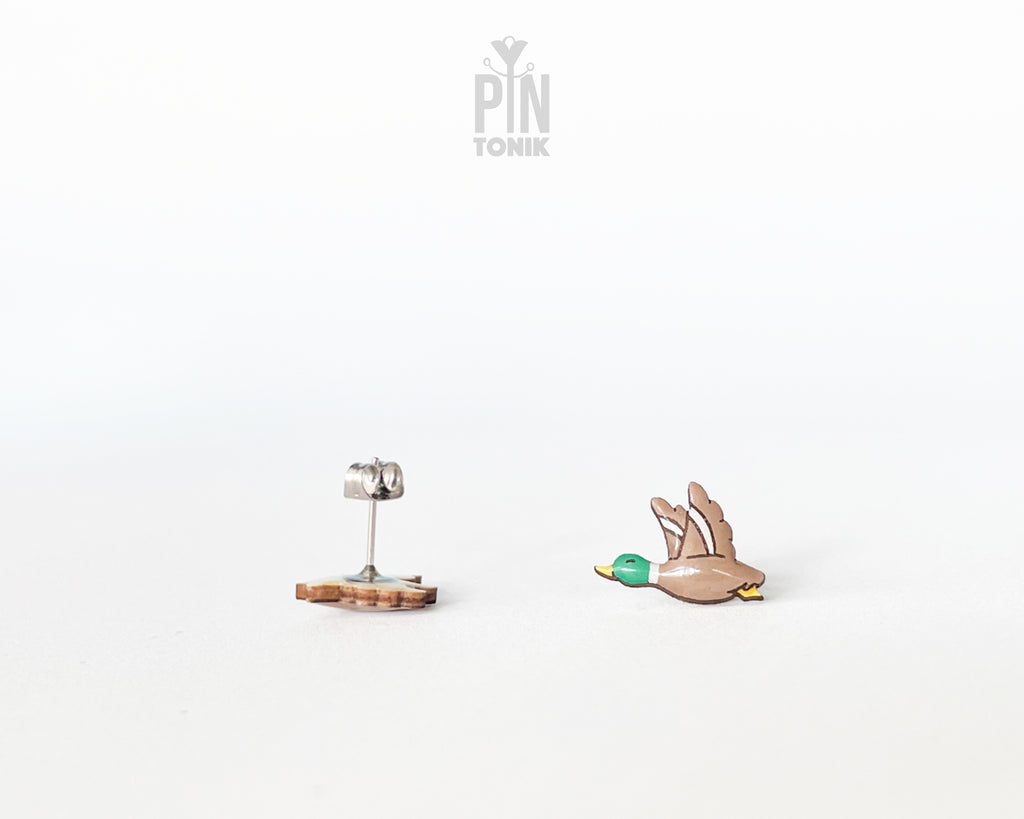 Pair of hand-painted wooden flying mallard duck stud earrings with wings spread and a glossy resin finish