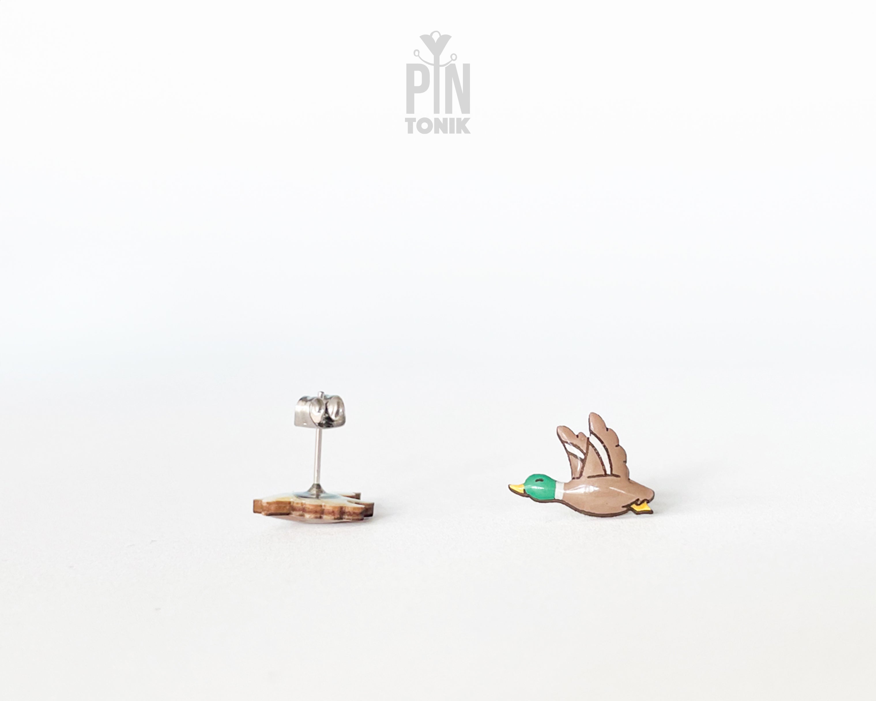 Pair of hand-painted wooden flying mallard duck stud earrings with wings spread and a glossy resin finish