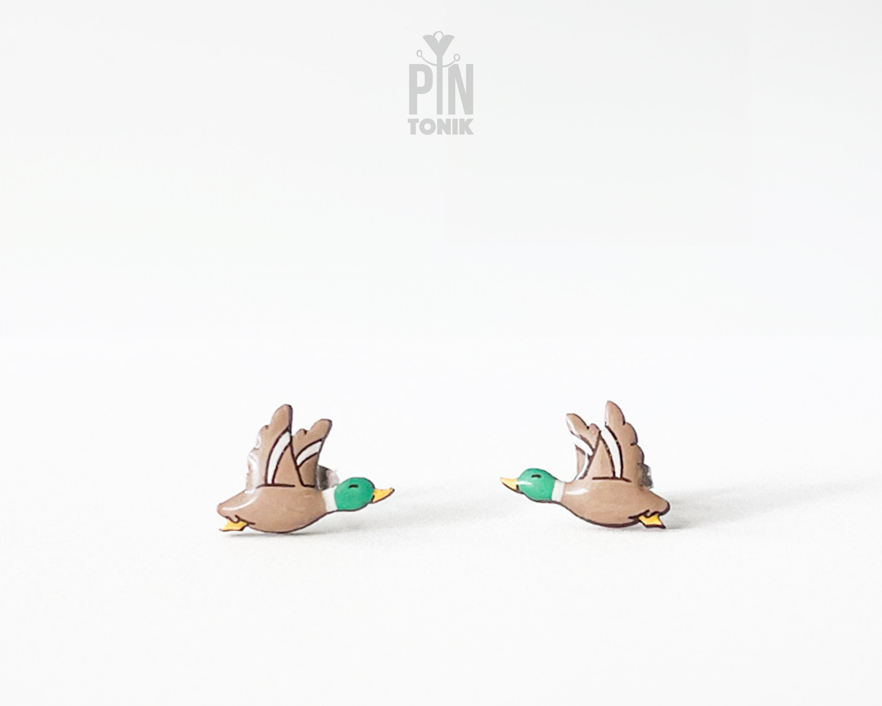 Pair of hand-painted wooden flying mallard duck stud earrings with wings spread and a glossy resin finish