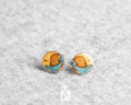 Handmade wooden stud earrings featuring a little blue whale sleeping inside a yellow crescent moon by PinTonik.