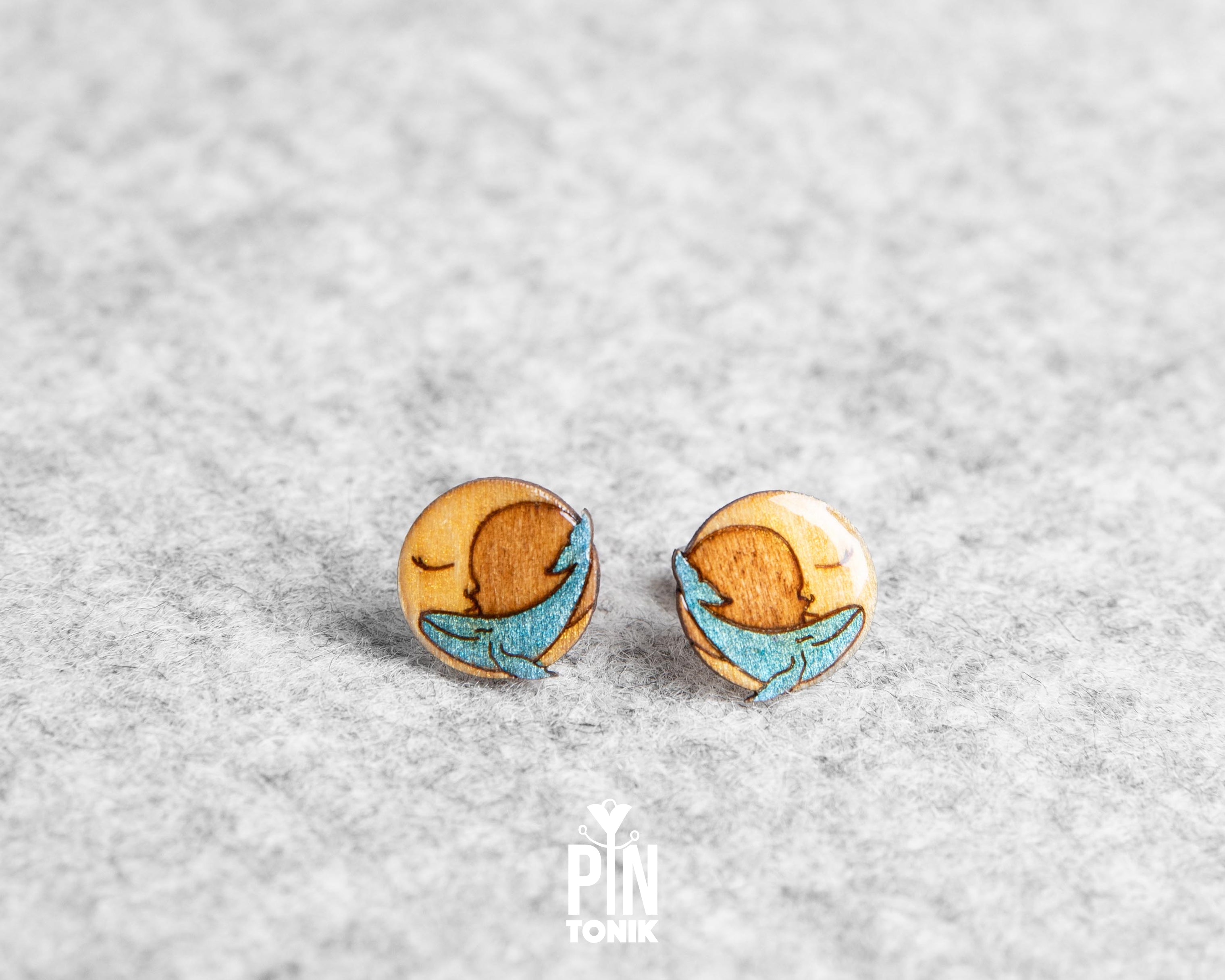 Handmade wooden stud earrings featuring a little blue whale sleeping inside a yellow crescent moon by PinTonik.