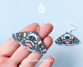 Large hand-painted wooden Agarista Agricola moth dangle earrings with intricate navy, pink, and yellow wing patterns on sterling silver hooks