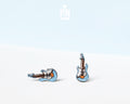 Two small guitar-shaped stud earrings on a clean white surface with a pale blue background. Earrings show a white body with blue edges and brown neck