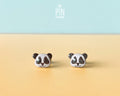 Pair of hand-painted wooden panda face stud earrings with a high-gloss resin finish