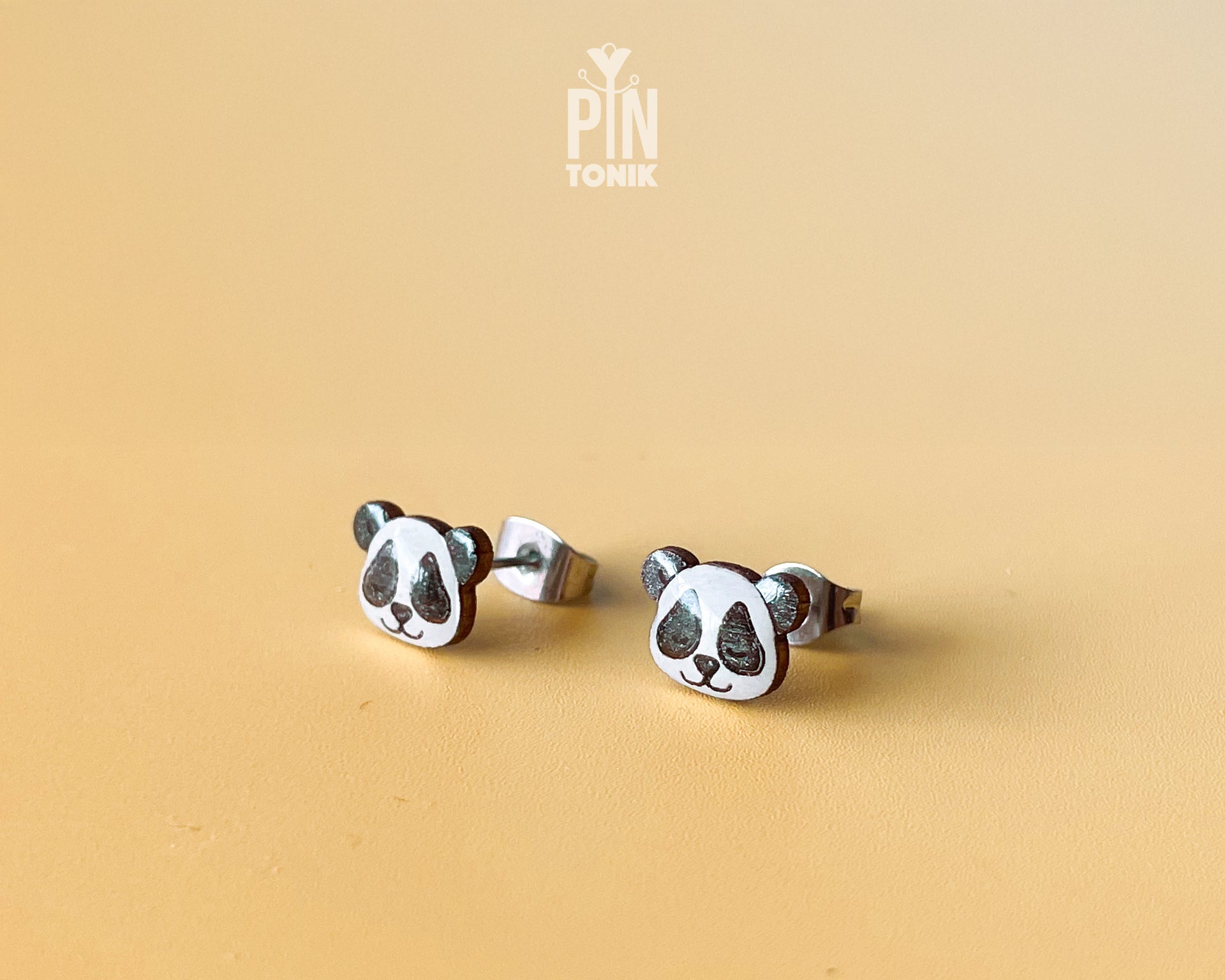 Pair of hand-painted wooden panda face stud earrings with a high-gloss resin finish